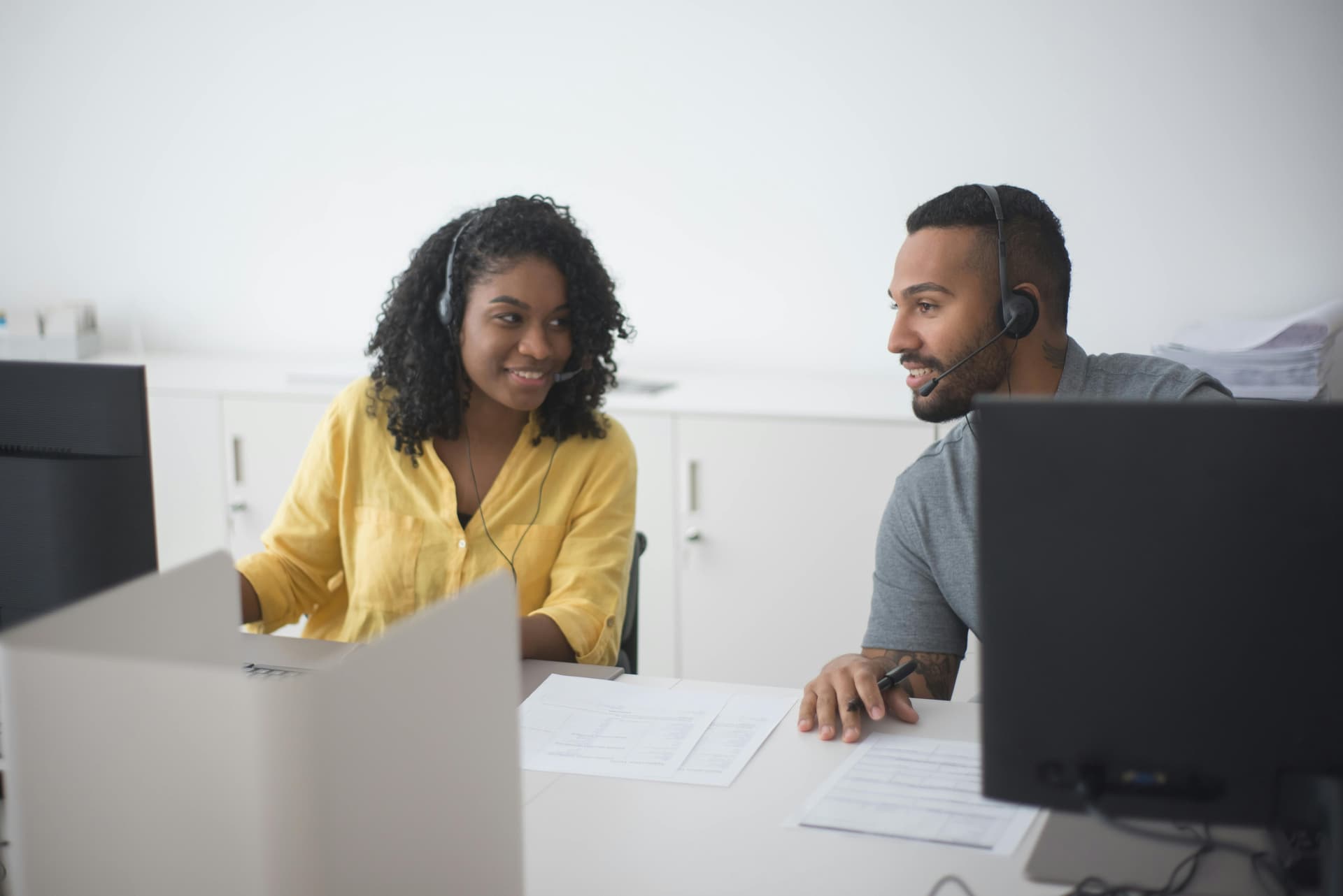 Two call center agents collaborating on customer inquiries
